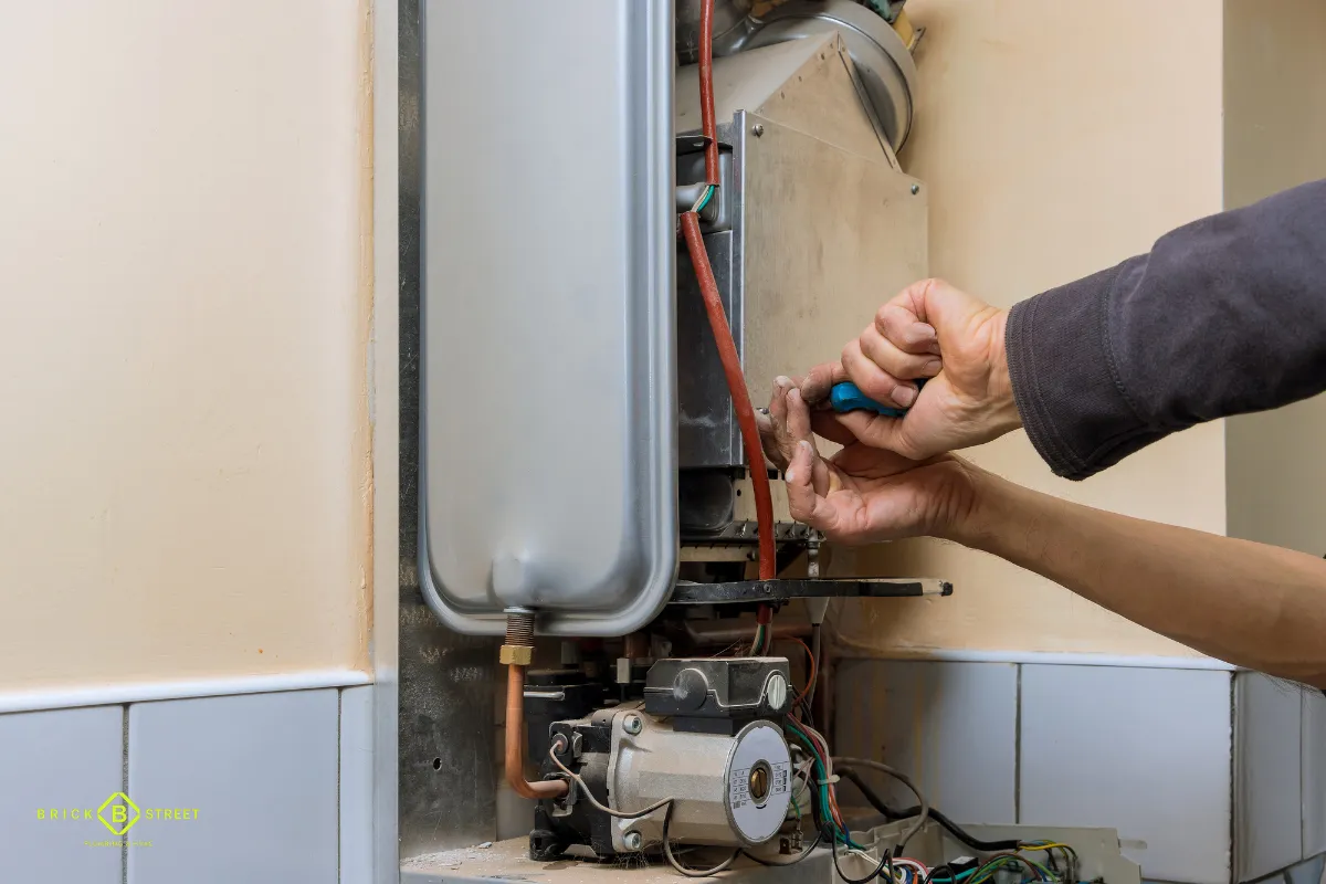 Technician servicing a wall-mounted heating unit