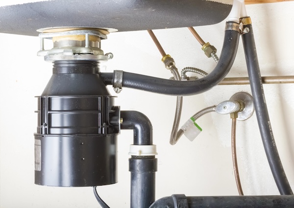 image of garbage disposal under a sink